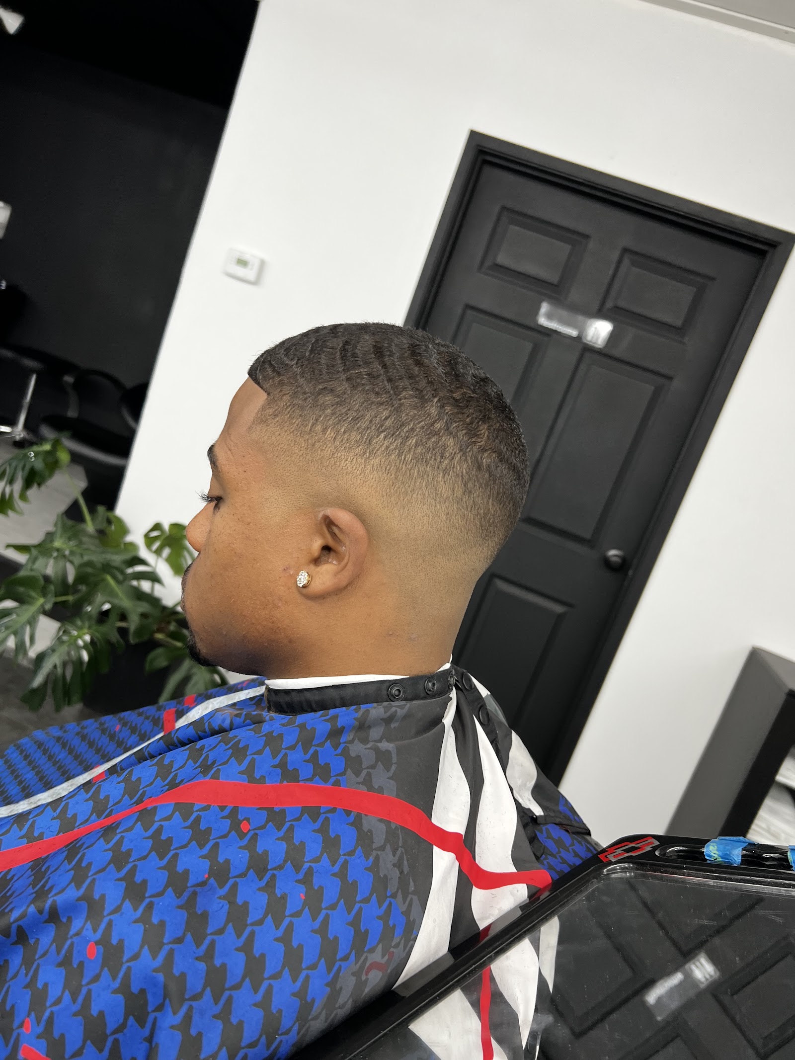 Side profile of a man with 360 waves and a clean skin fade