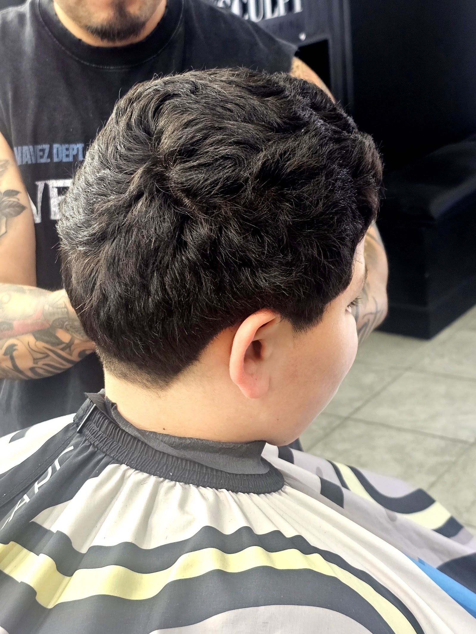 Back view of a textured tapered haircut on a client