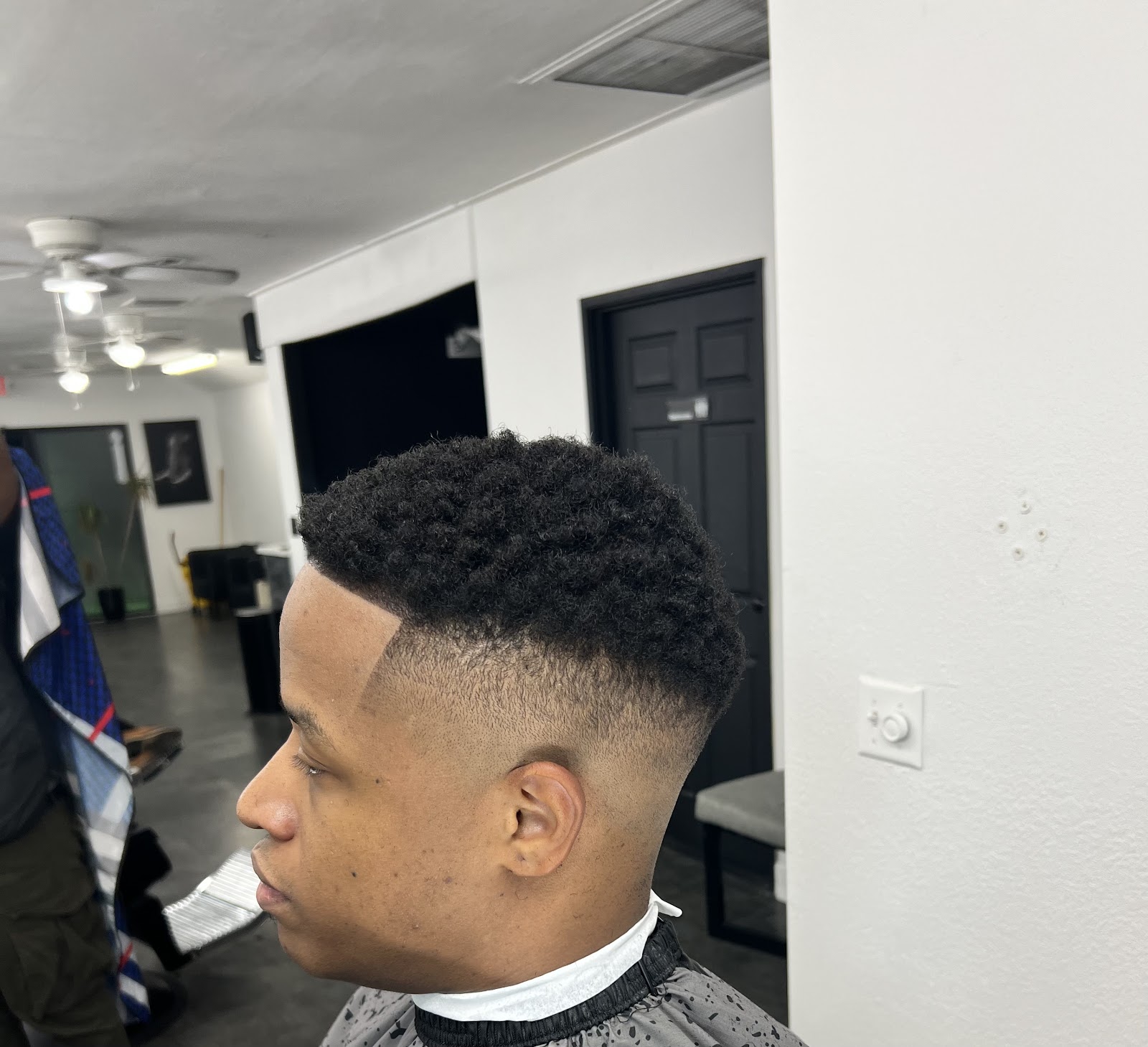 Side view of an afro with a clean line-up and drop fade
